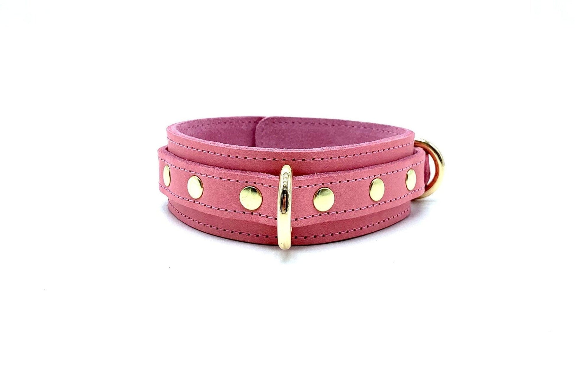 Elegant pink leather collar from the Tango Pink BDSM Kit, enhanced with gold hardware. This collar is a symbol of luxury and restraint, perfectly blending style and functionality for BDSM play.