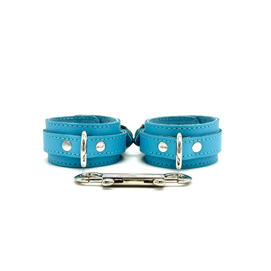 light blue leather handcuffs 1.5inch wide, featuring silver center D ring and double ended snap hook connector.