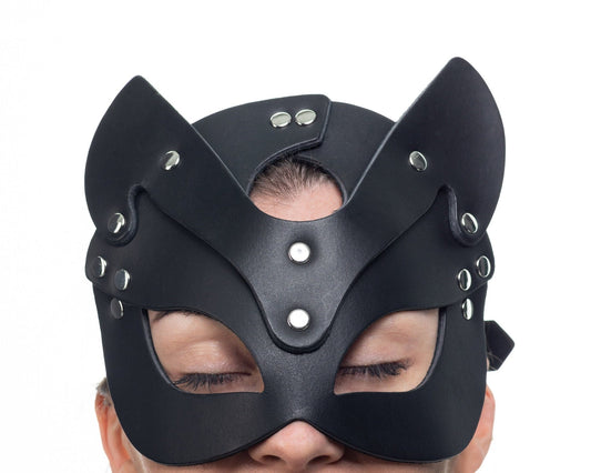Lulexy black cat mask, meticulously crafted from Italian leather with a matching black suede lining. Features best quality hardware, pointed ears, and eye cutouts for a sophisticated and mysterious appearance.