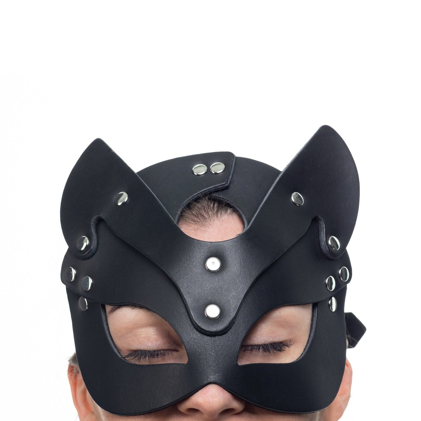 Lulexy black cat mask, meticulously crafted from Italian leather with a matching black suede lining. Features best quality hardware, pointed ears, and eye cutouts for a sophisticated and mysterious appearance.