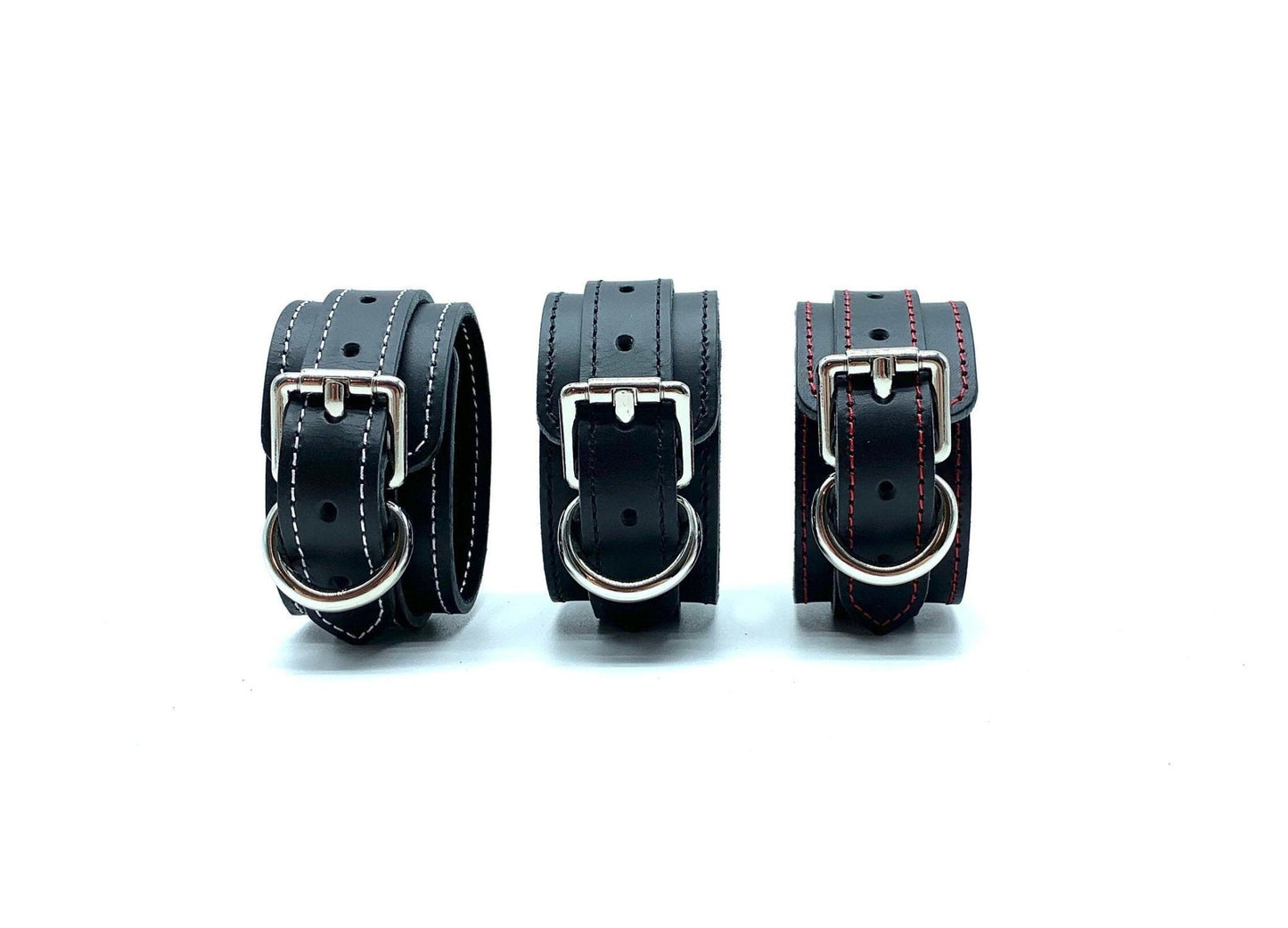 Collection of Italian BDSM bondage handcuffs in Scarlet design, featuring handcuffs crafted from black leather and red suede with variations in white, red, and black stitching, showcasing exquisite craftsmanship and versatile style for discerning bondage enthusiasts.