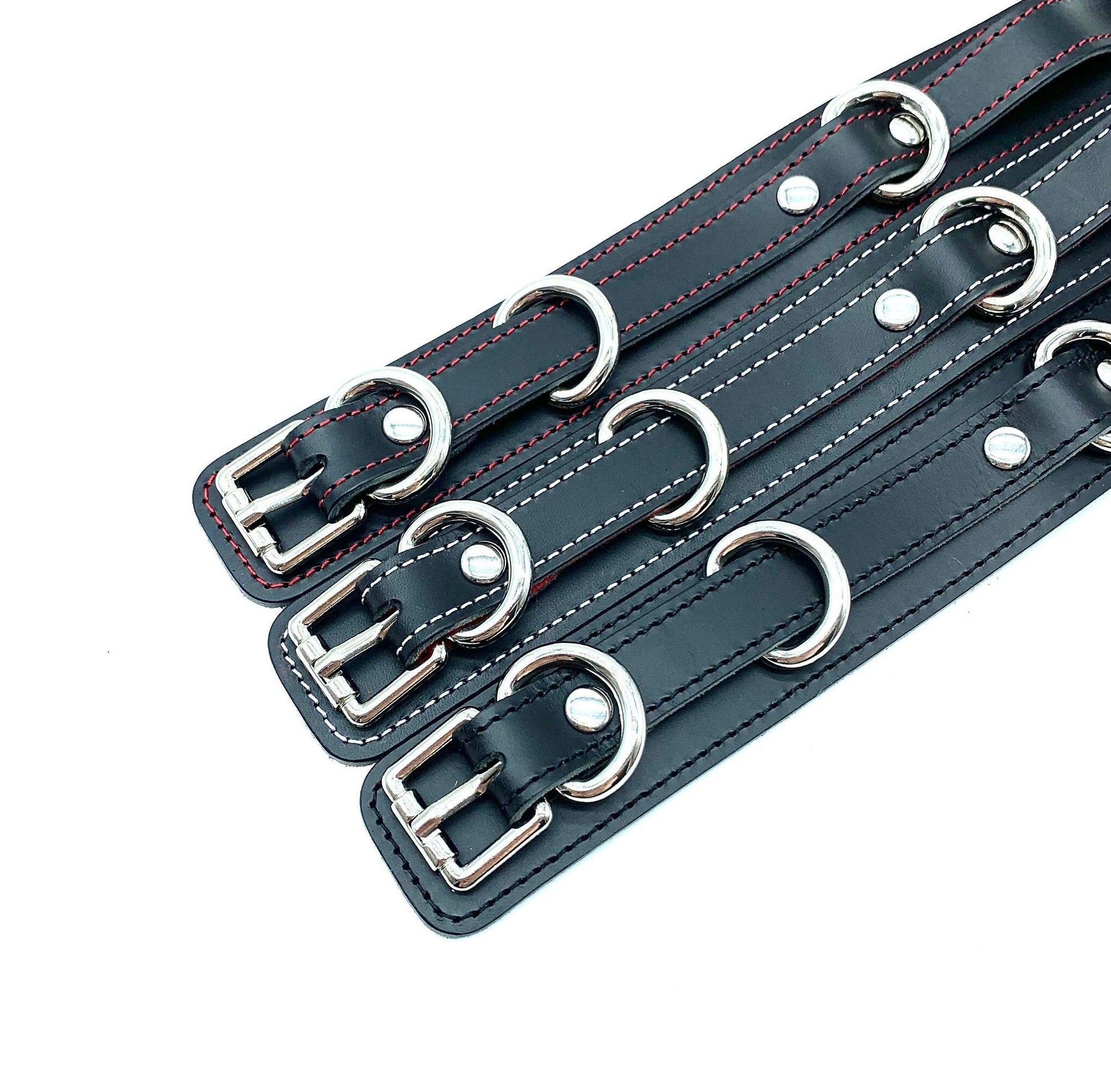 Picture of Different Stitching: Detailed view of the intricate stitching on Scarlet Italian leather BDSM bondage thigh cuffs, showcasing the meticulous craftsmanship with Italian leather, produced in the USA.
