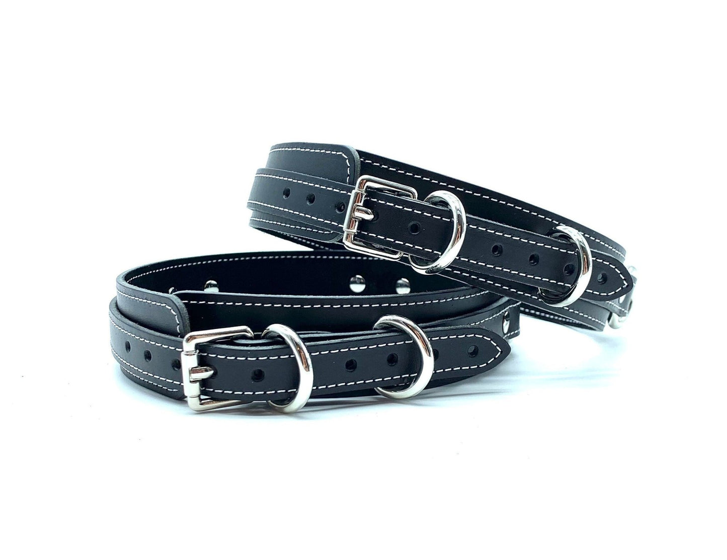 Back view of lulexy Tango Black Italian leather BDSM bondage thigh cuffs, detailing the intricate silver buckles that ensure a secure fit, presented against a contrasting background to highlight the luxurious craftsmanship.