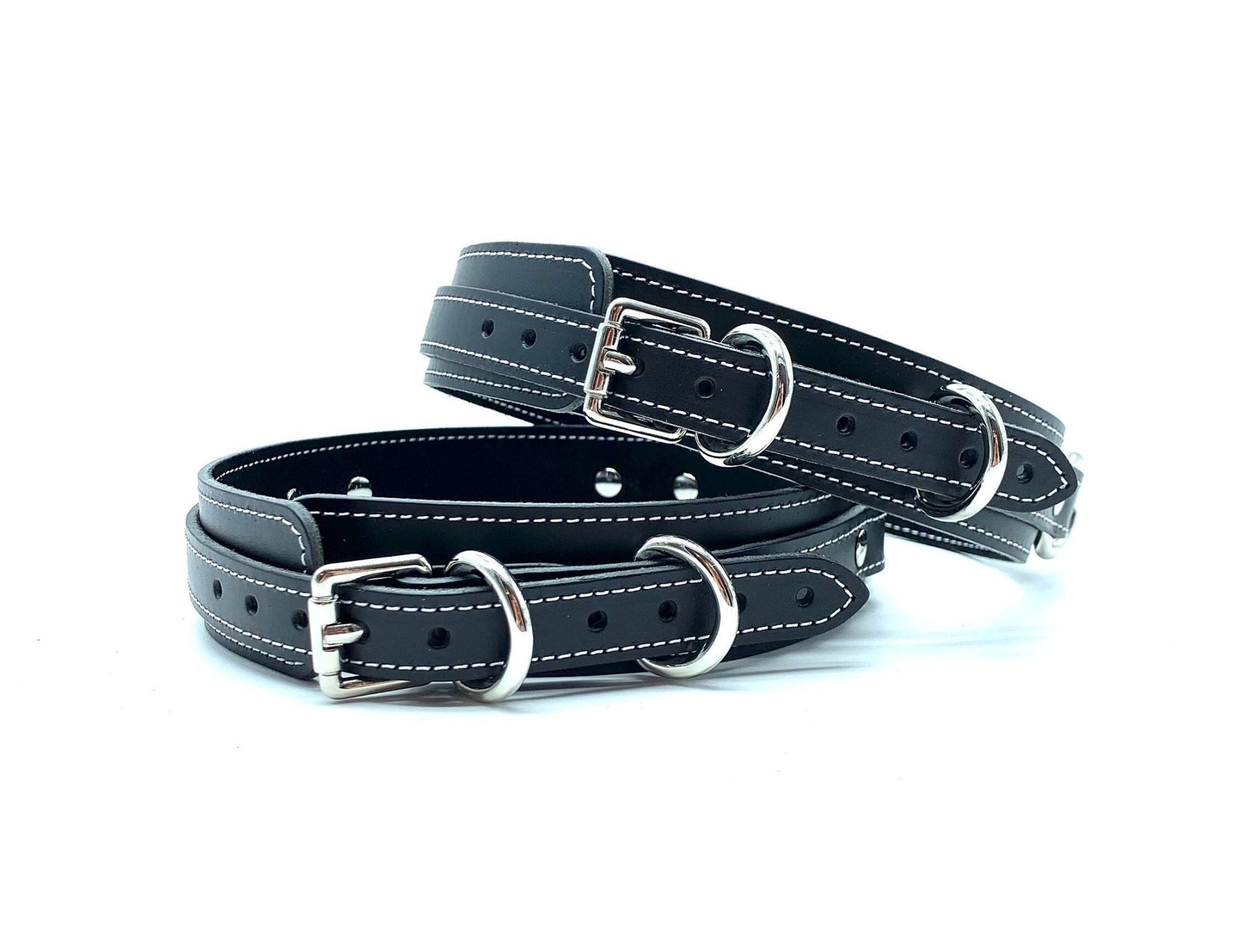 Back view of lulexy Tango Black Italian leather BDSM bondage thigh cuffs, detailing the intricate silver buckles that ensure a secure fit, presented against a contrasting background to highlight the luxurious craftsmanship.