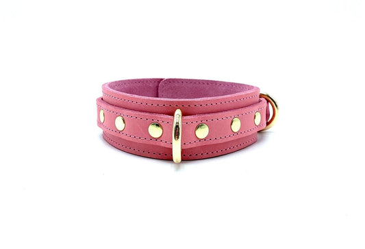 Pink leather collar with gold studs and hardware, adjustable design with smooth finish and luxury detailing