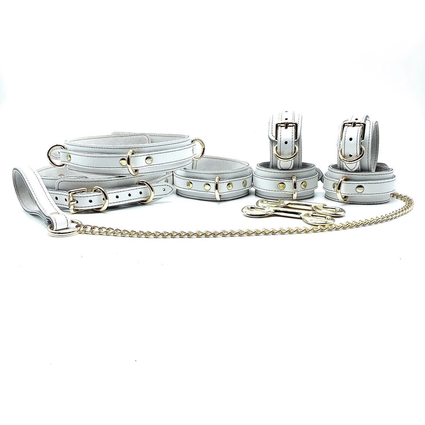 Set of 7 Pieces: A collection of seven Vienna-colored Italian leather thigh cuffs, each with consistent pale coloring and silver hardware, arranged side by side to display their uniform design.