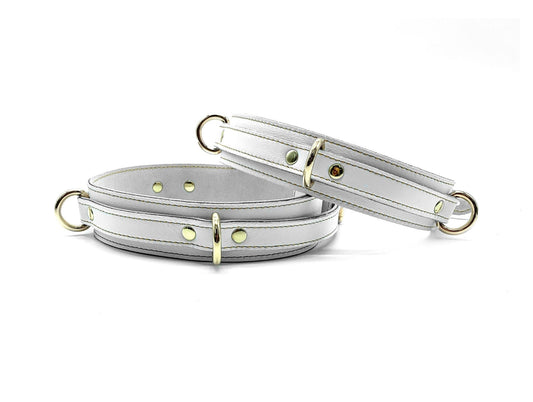 Front Picture of Thigh Cuffs: Frontal view of Vienna-colored Italian leather thigh cuffs, featuring a delicate pale hue, complemented by polished silver-tone hardware, against a clean, white background.
