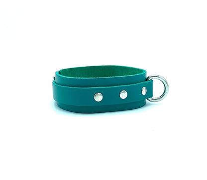 Side view of the Candice Collection collar made from teal leather, showcasing the fine craftsmanship and silver hardware that enhance its sophisticated appearance.