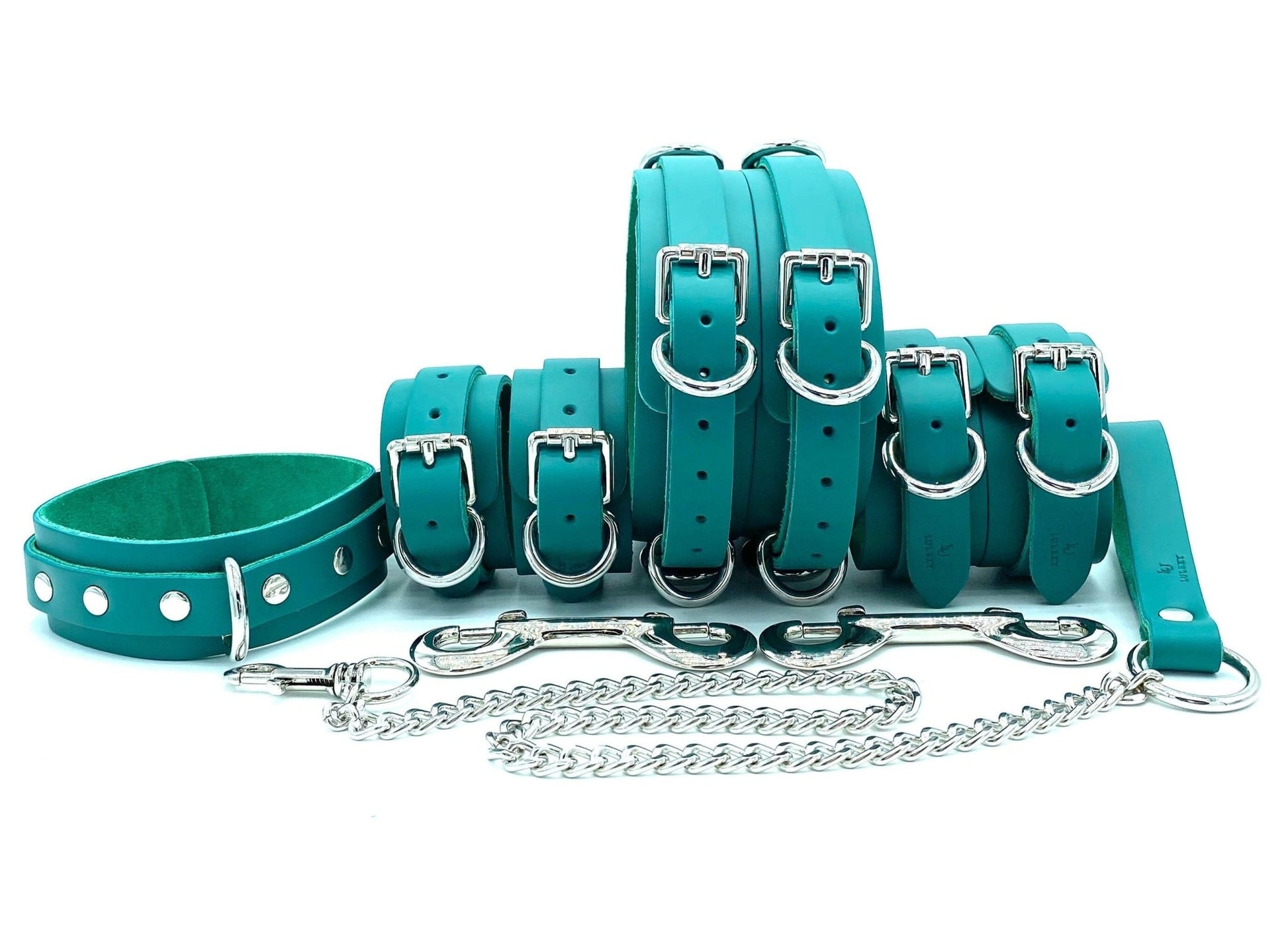 Candice Collection BDSM kit, showcasing the entire set including handcuffs, ankle cuffs, a collar with leash, and thigh cuffs. Each piece is crafted from luxurious teal leather and teal suede, finished with silver hardware, designed for those who seek both style and function in their bondage gear.