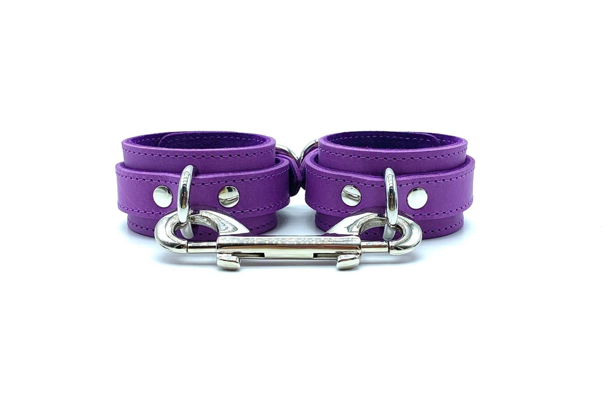 Five purple cuffs in the Tango Purple BDSM Kit, connected on the side with silver hardware, enhancing the BDSM experience with superior bondage features and exquisite craftsmanship.