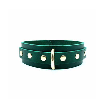 Green leather collar 1.5 inch wide with center D ring and gold rivets on each side of the ring.
