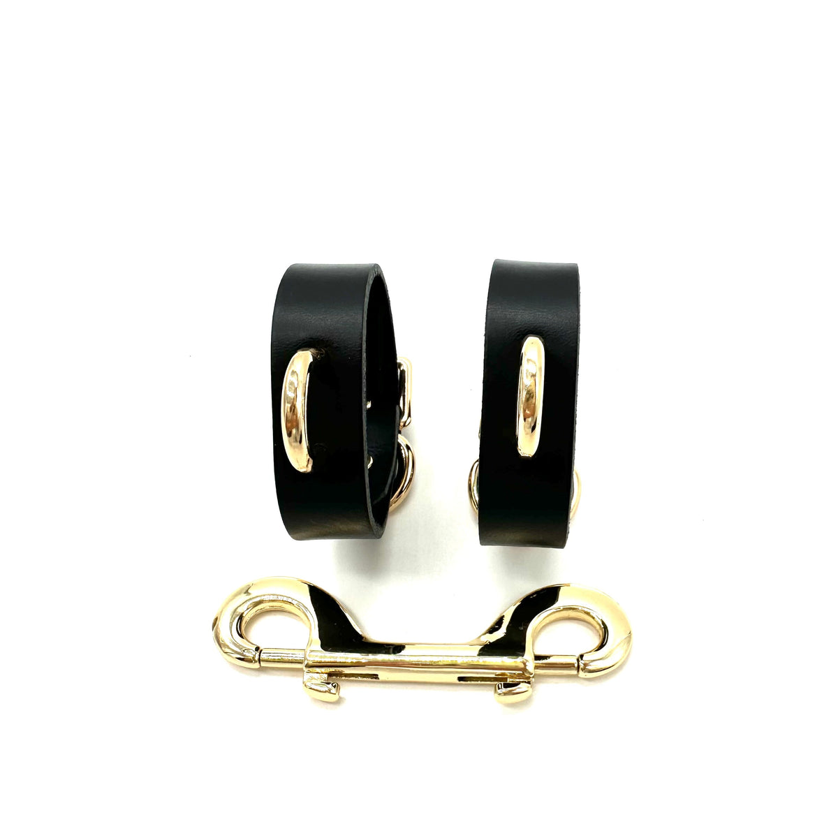 Slim black Italian leather handcuffs with gold D ringa and metal connector