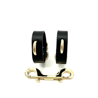 Slim black Italian leather handcuffs with gold D ringa and metal connector
