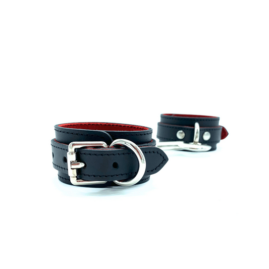 1.5inch black leather handcuffs with red suede lining and silver buckle.
