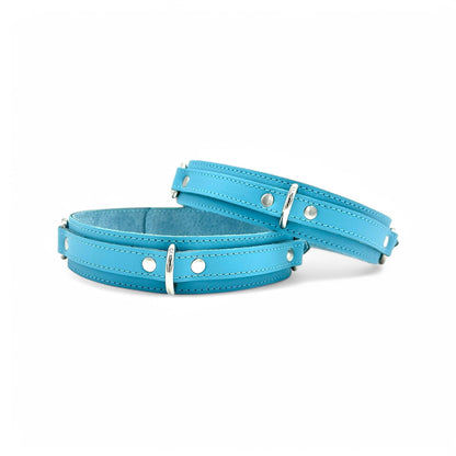 Light blue leather thigh cuffs with detailed stitching and silver D-rings for attachment points.