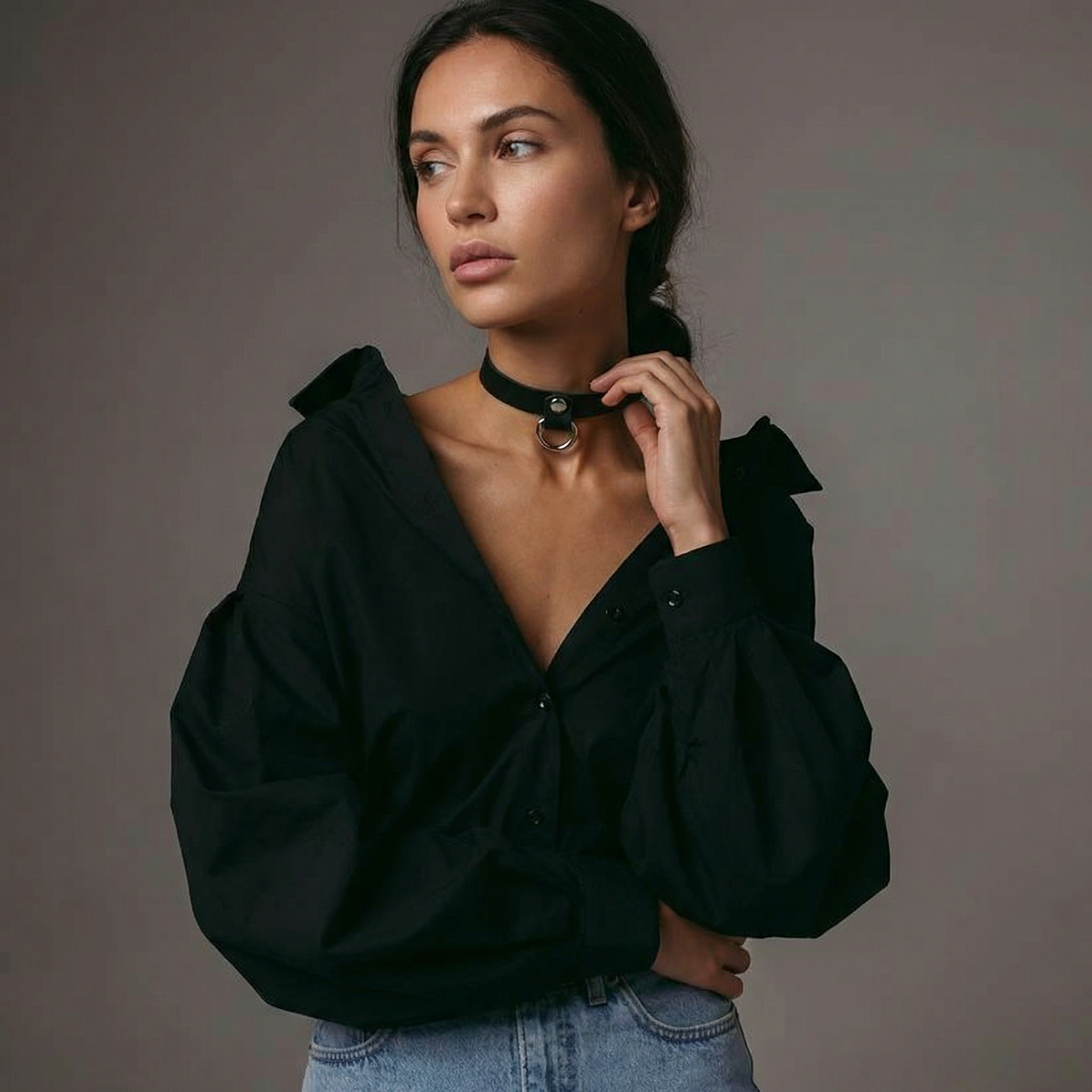 Model wearing a black Italian leather choker with silver D-ring hardware, styled with a black blouse and jeans.