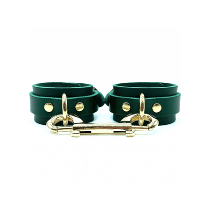 green leather handcuffs with center gold D-ring and double ended snap hook connector.