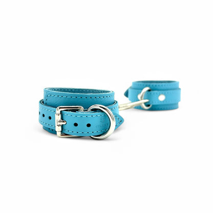 Light blue leather handcuffs showcasing elegant silver buckle and adjustment strap with detailed stitching and Lulexy logo.