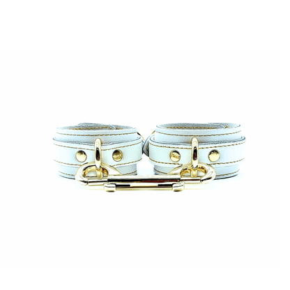white Italian leather handcuffs 1.5inch wide, gold stitching, gold center D rings and double ended snap hook connector.