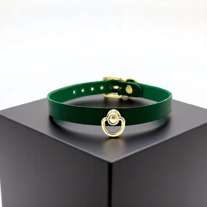 Green Buttero Italian leather choker with gold hardware and center D-ring, minimalist collar on display