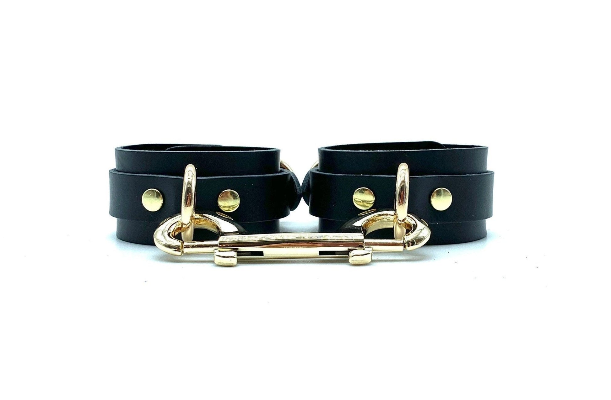 Luxurious Italian leather handcuffs with gold hardware and matching connector, exuding sophistication and premium quality for BDSM play, handcrafted in the USA, combining style with ultimate comfort and durability.