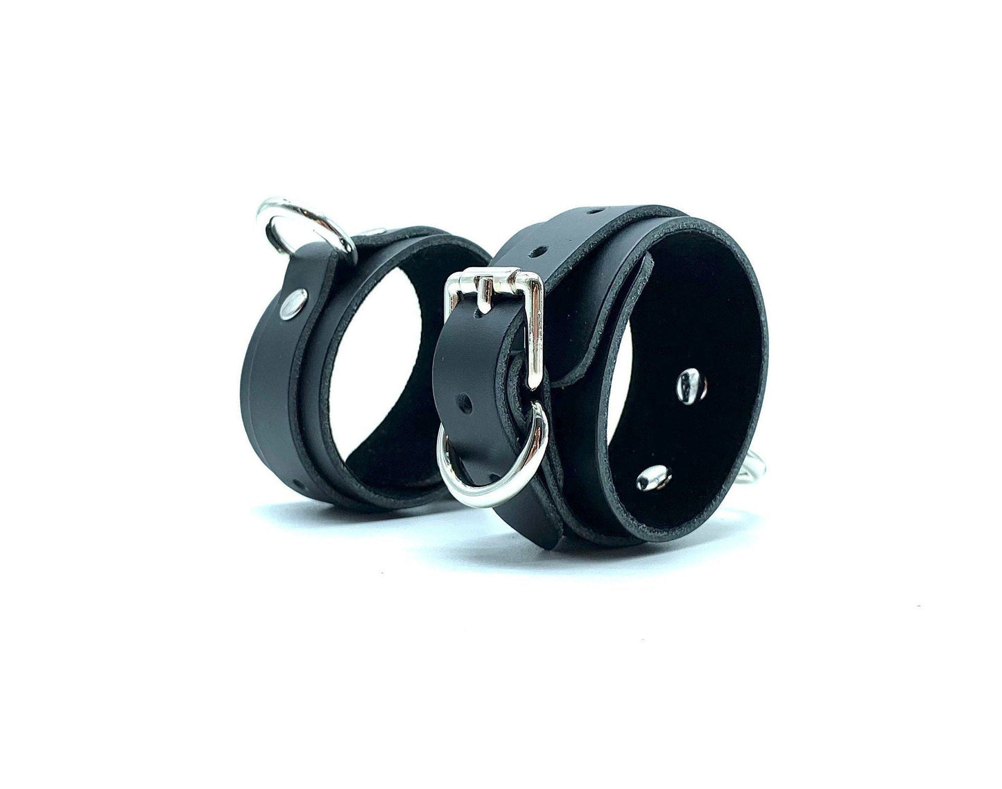 Elegant standing display of Italian suede handcuffs, highlighting the meticulous craftsmanship and premium nickel hardware, ideal for BDSM users looking for luxury and comfort in bondage gear, made in the USA.