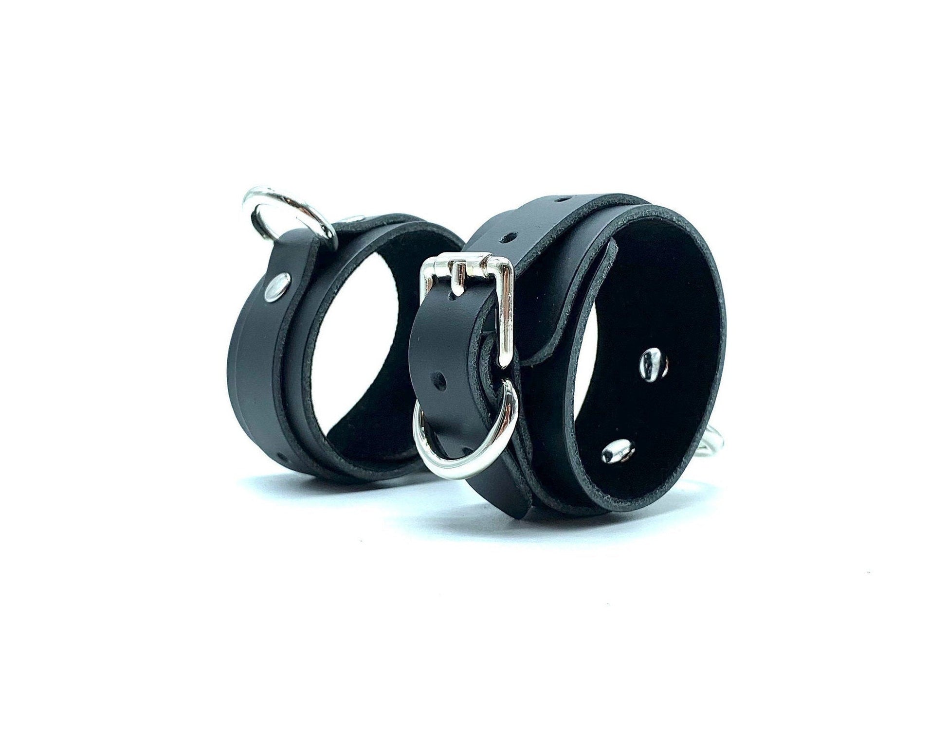 Elegant standing display of Italian suede handcuffs, highlighting the meticulous craftsmanship and premium nickel hardware, ideal for BDSM users looking for luxury and comfort in bondage gear, made in the USA.