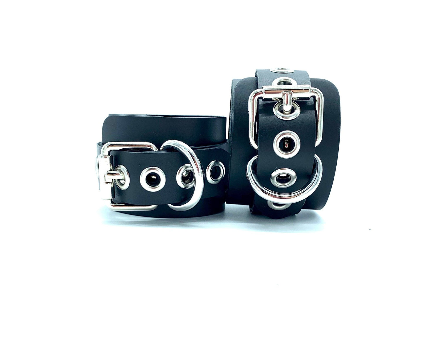 Italian 2" BDSM bondage cuffs made in the USA, positioned similarly to the previous image, highlighting the elegant silver buckles that enhance the visual appeal and durability of these premium cuffs crafted for discerning bondage enthusiasts.