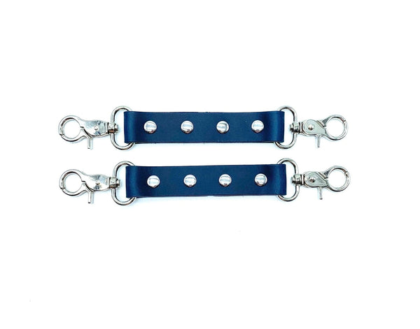 Blue leather connector straps with silver hardware and clips, adjustable restraint connectors with rivet detail