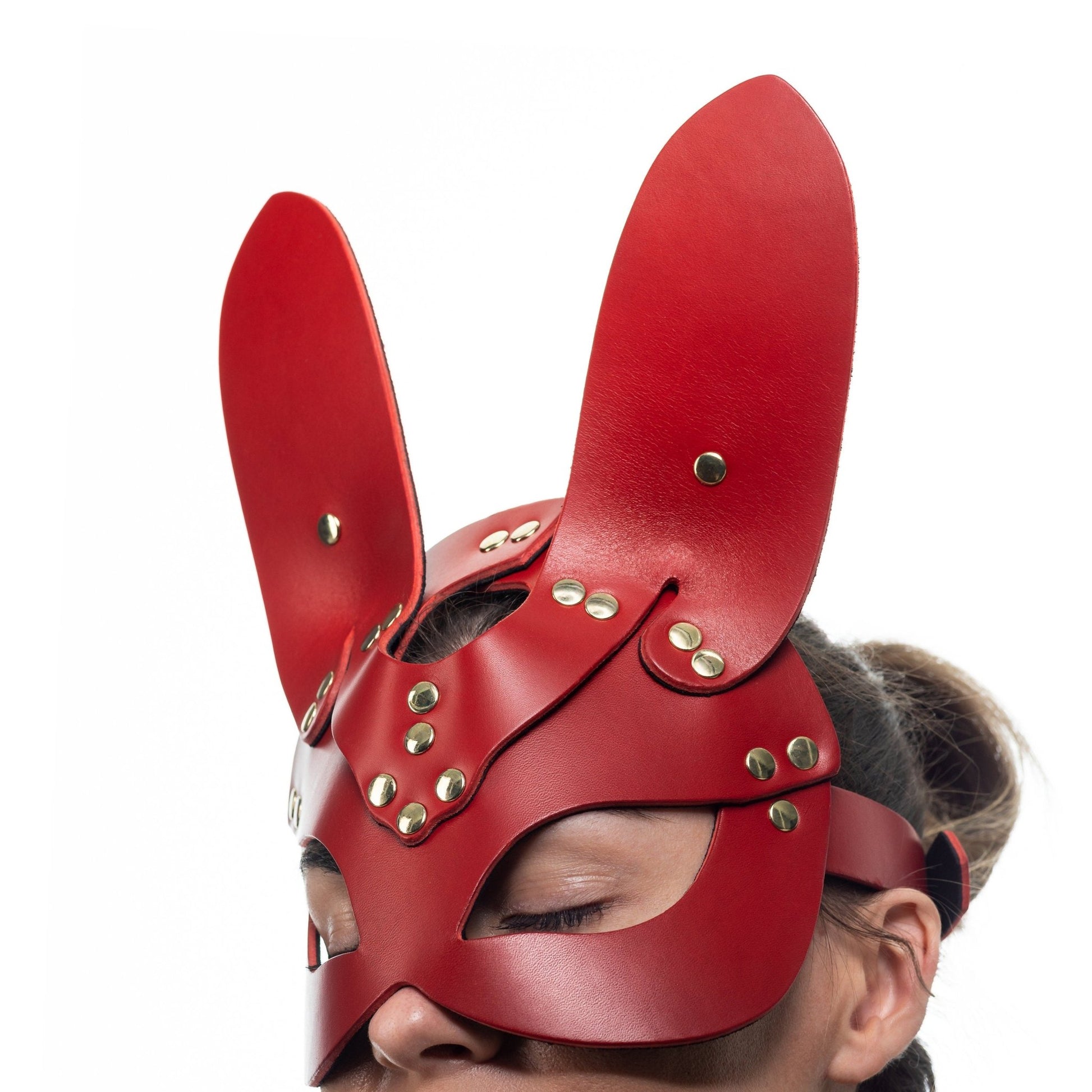 Lulexy red bunny mask, crafted from premium Italian leather and lined with matching red suede. The mask features elongated bunny ears and high-quality hardware, exuding a playful yet luxurious aura in a vibrant red hue.