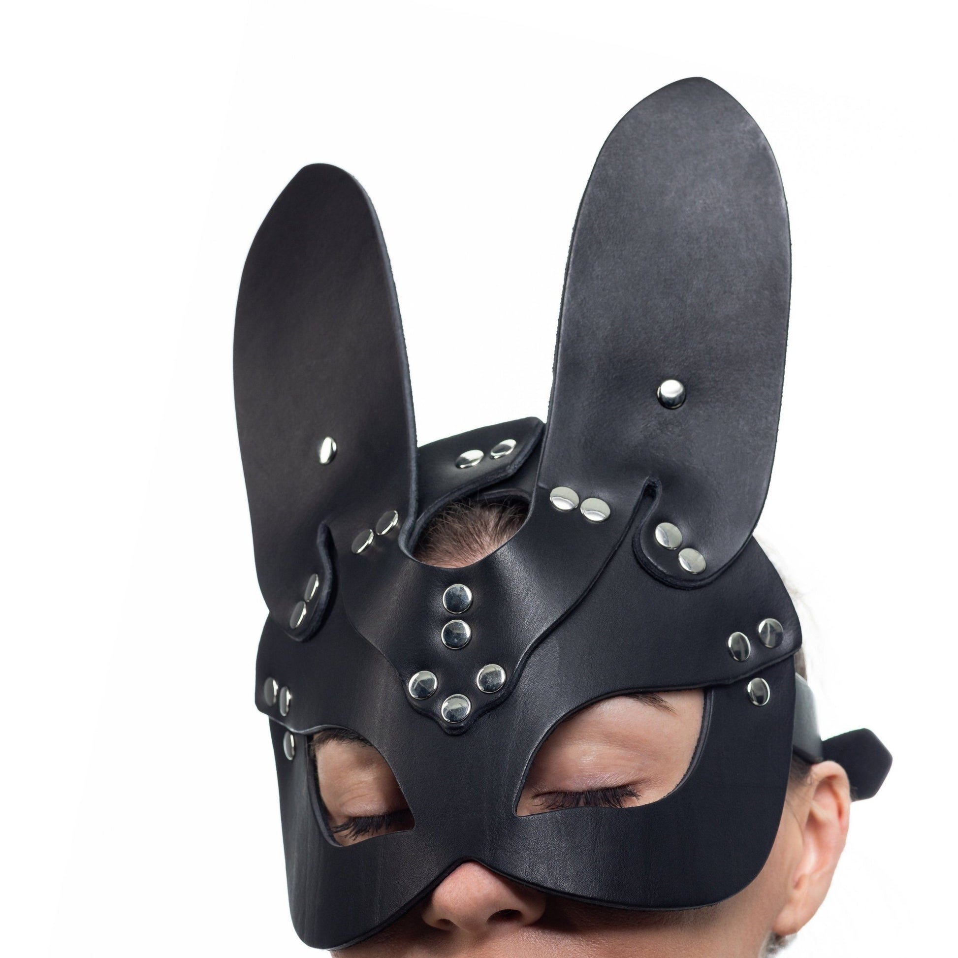 Lulexy black bunny mask, meticulously made from Italian leather with a matching black suede lining. It includes tall, pointed bunny ears and superior hardware, combining elegance with a touch of whimsy in a classic black color.