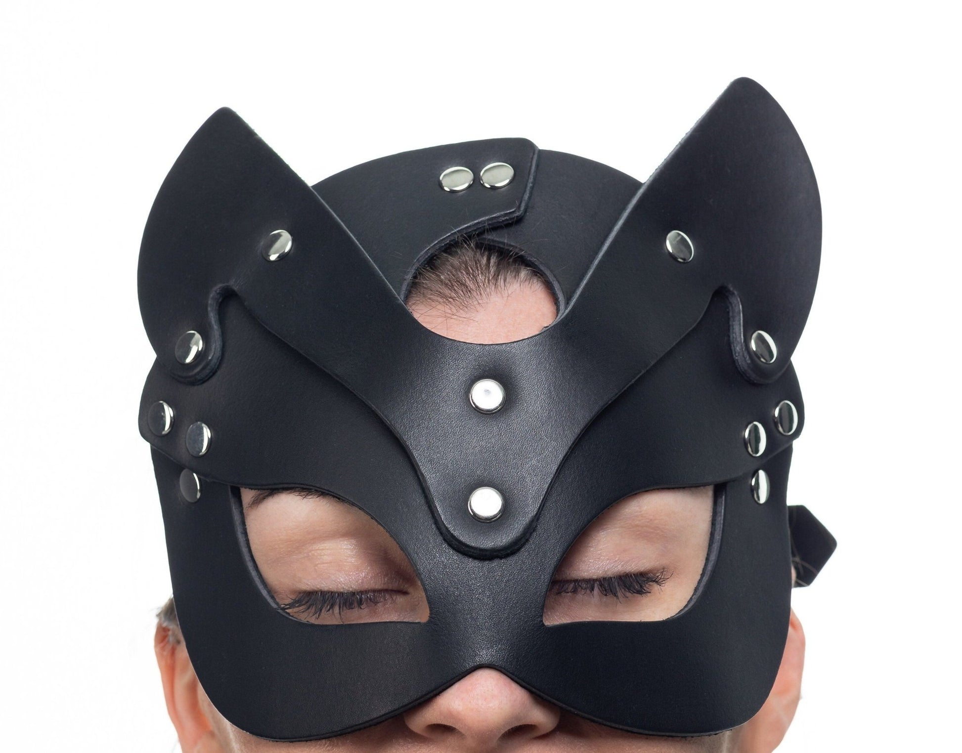 Lulexy black cat mask, meticulously crafted from Italian leather with a matching black suede lining. Features best quality hardware, pointed ears, and eye cutouts for a sophisticated and mysterious appearance.