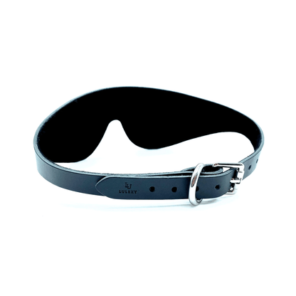 Black leather blindfold side view with strap, adjustable buckle and smooth finish