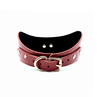 Back view of red leather posture collar with gold buckle, multiple adjustment holes and gold hardware.