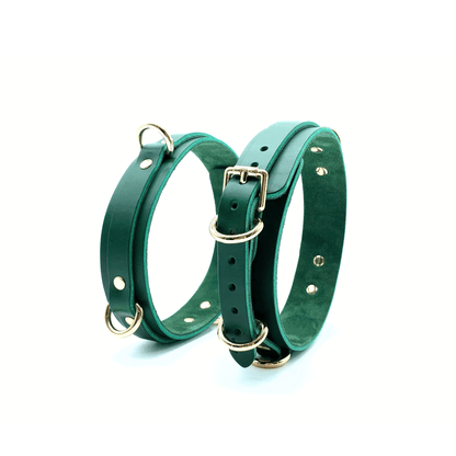 Green Italian leather thigh cuffs with gold hardware, adjustable straps with buckle and rivet detail