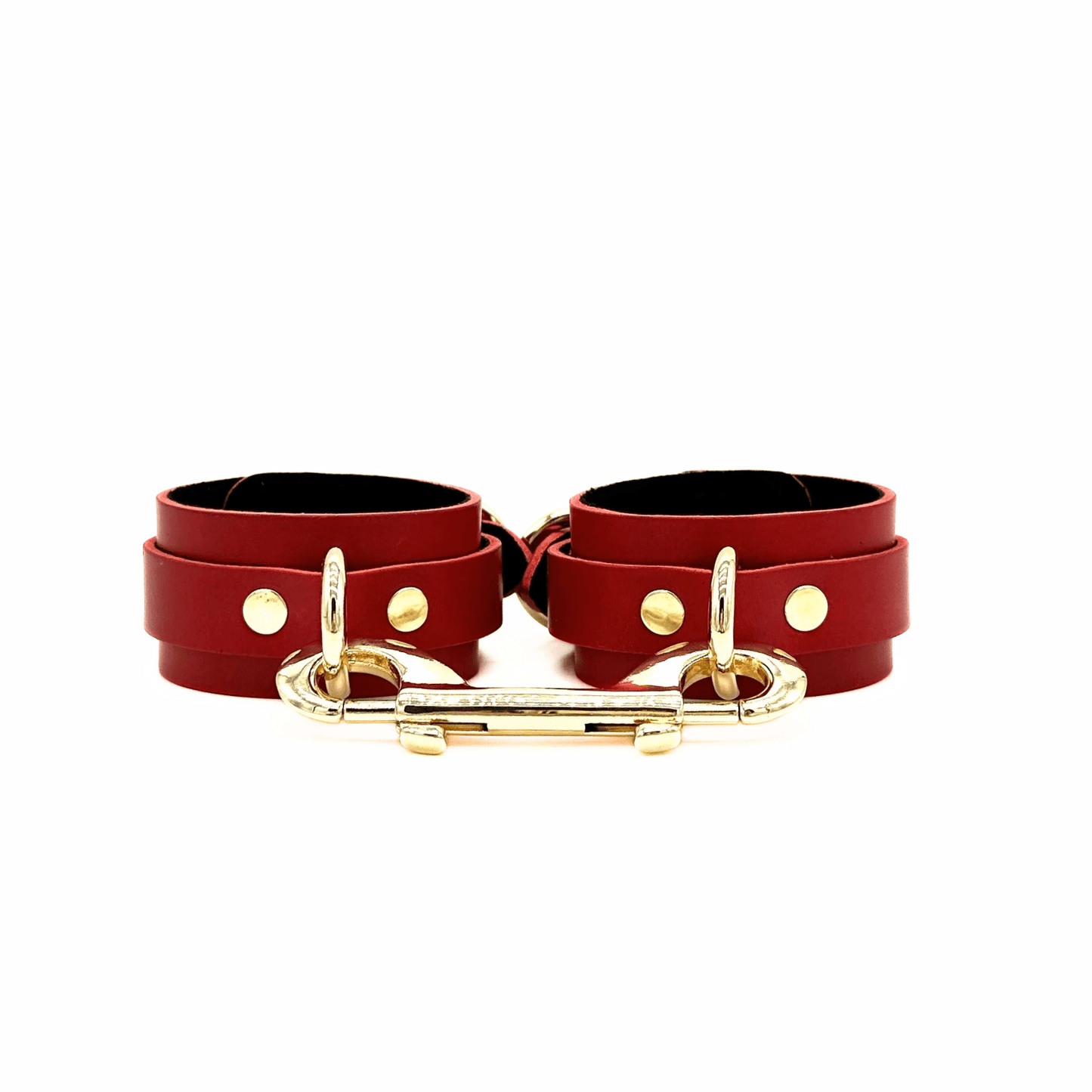 Red leather ankle cuffs with gold hardware and double ended snap hook connector.