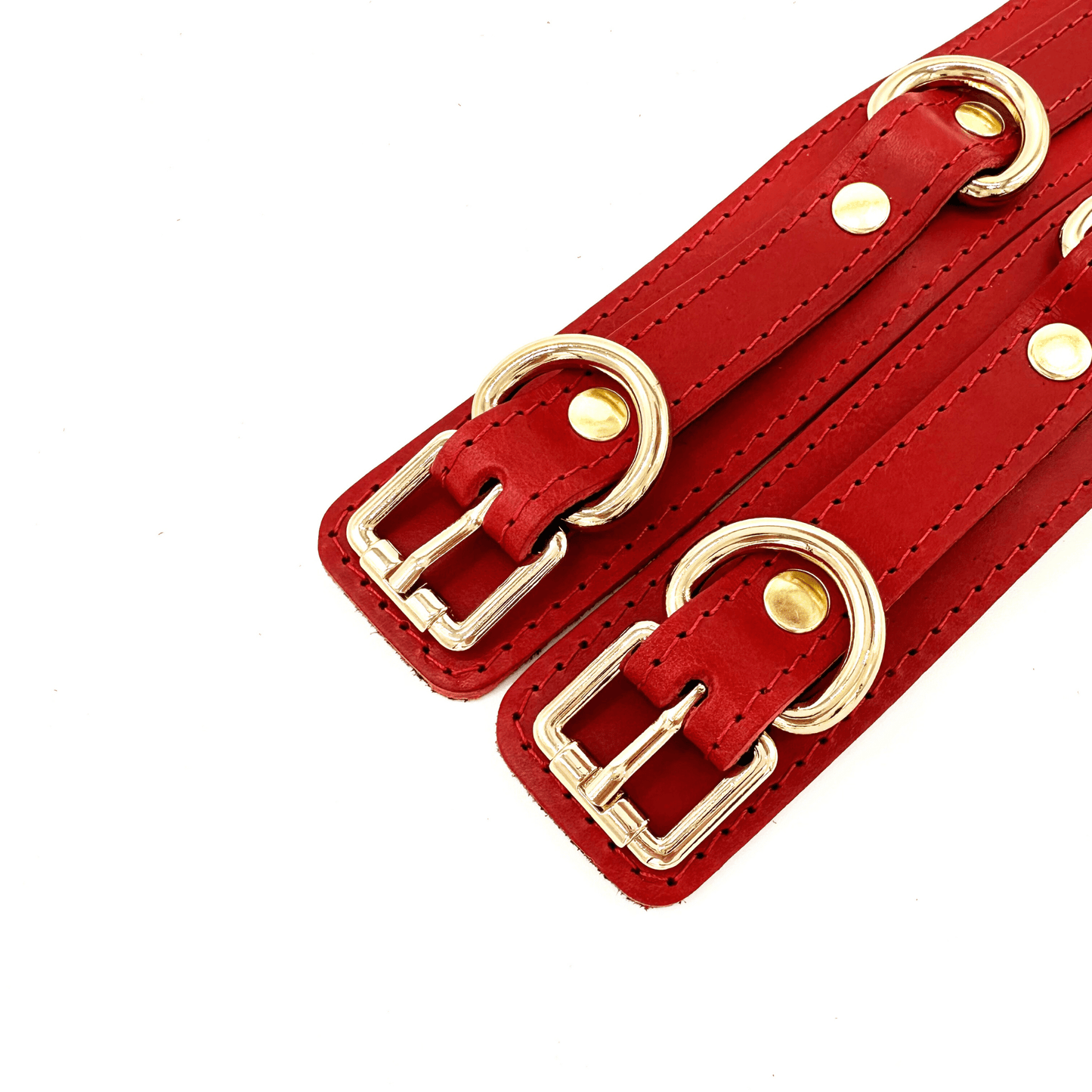 Red leather handcuffs with gold hardware, adjustable wrist cuffs with buckle closure