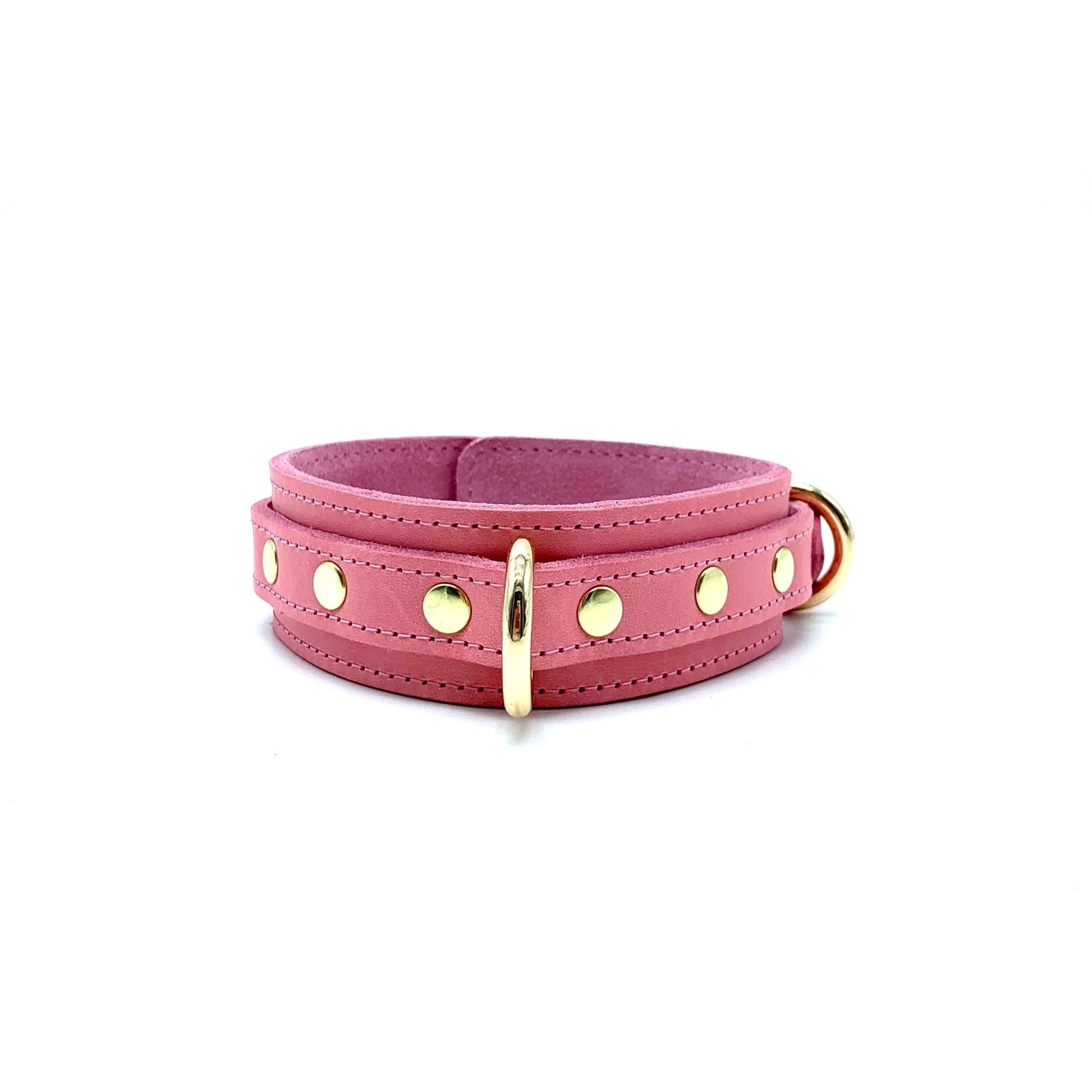 light pink leather collar showcasing detailed stitching, gold center D ring and rivets on each side of the ring.