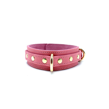 light pink leather collar showcasing detailed stitching, gold center D ring and rivets on each side of the ring.