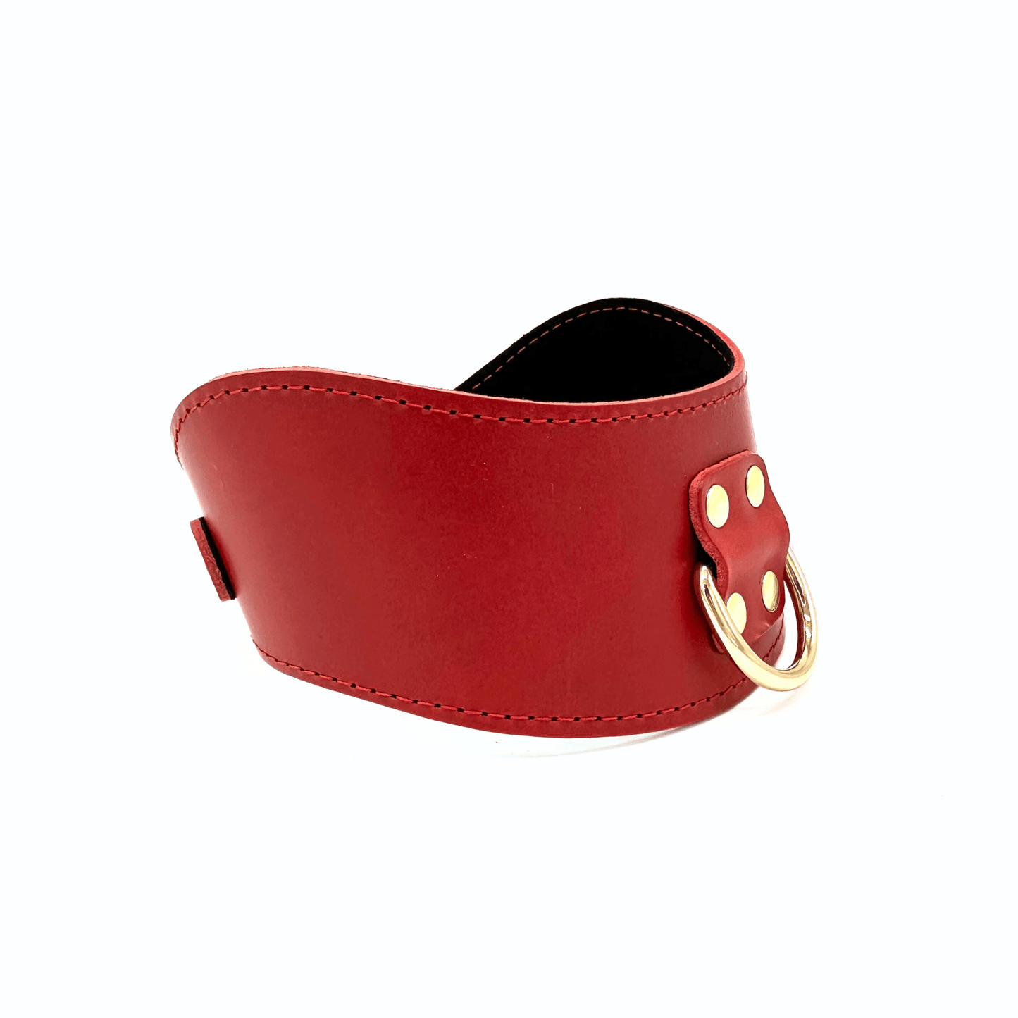 Side view of red leather posture collar with curved shape, fine stitching, and gold D-ring hardware on white background.