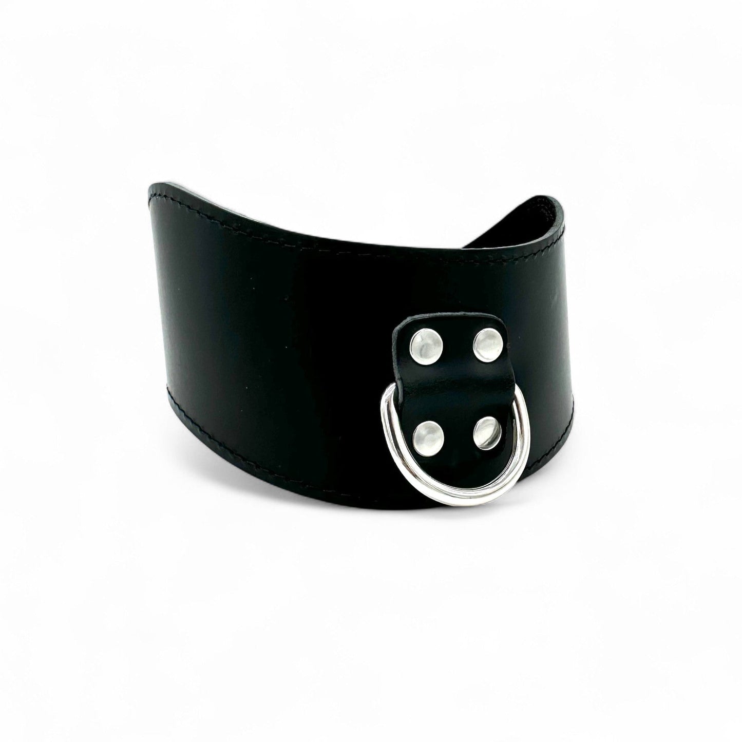 Side view of black Italian leather posture collar with large D ring in the center.