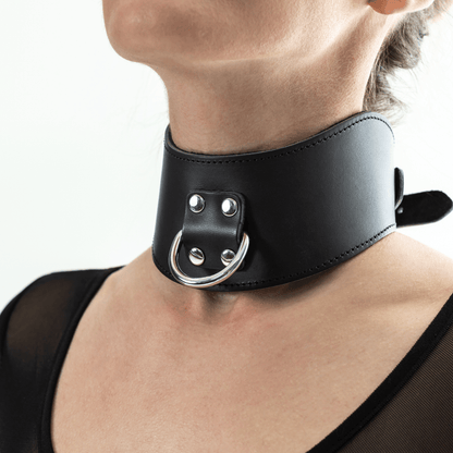 Black leather posture collar with silver hardware on a model in lifestyle setting