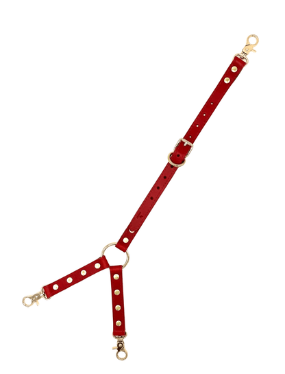 Red leather three way connector with gold hardware, adjustable Y-shape straps and clip ends on white background