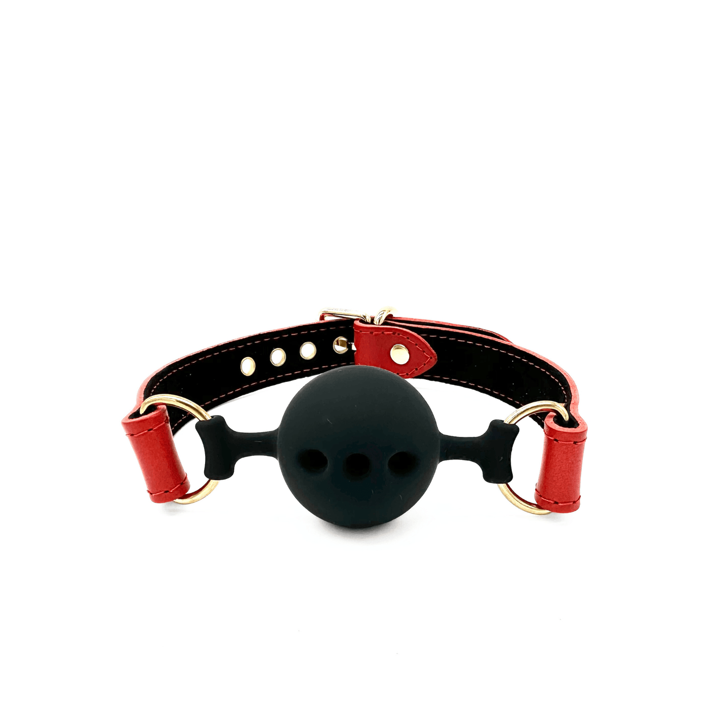 Red leather ball gag with adjustable strap, black silicone ball with breathing holes, and gold hardware on white background