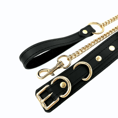 Black leather collar and chain leash set with gold hardware, D-ring detail and detachable gold chain