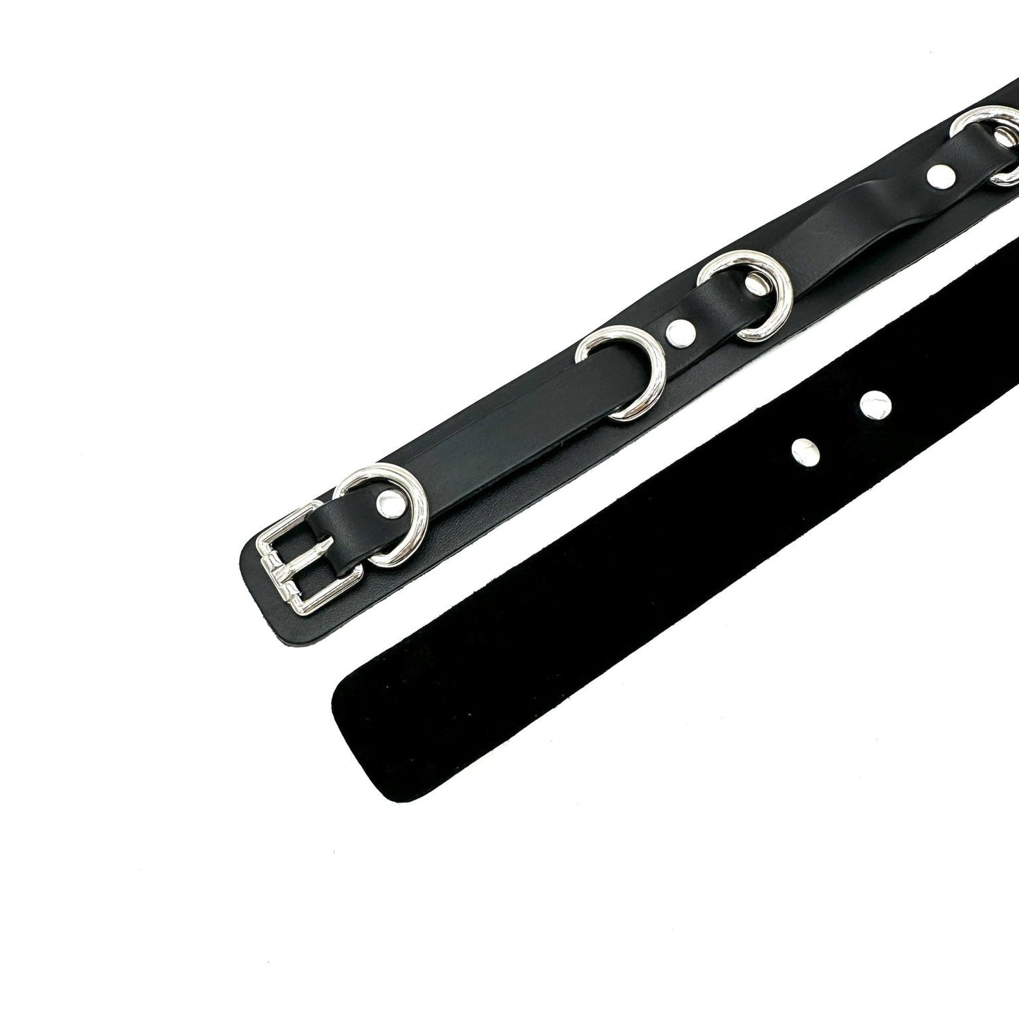Black leather thigh cuffs with silver hardware, front and back view showing smooth exterior and black suede lining