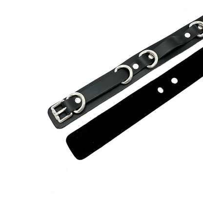 Black leather thigh cuffs with silver hardware, front and back view showing smooth exterior and black suede lining